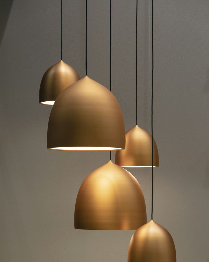 Cluster of brass pendant lights hanging at different heights